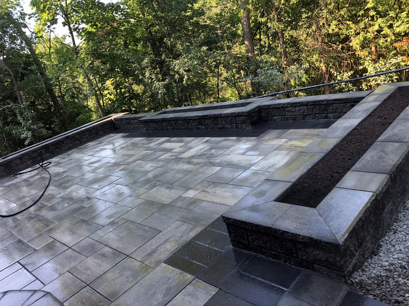 Stone patio and retaining wall installation in progress